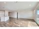 Bright living room with tile floors and sliding glass doors at 36530 W Leonessa Ave, Maricopa, AZ 85138