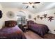 Guest bedroom with twin beds and decorative wall art at 3720 E South Fork Dr, Phoenix, AZ 85044