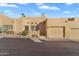 Tan stucco home with a two-car garage and desert landscaping at 37222 N Tom Darlington Dr # 2, Carefree, AZ 85377