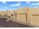 Tan stucco home with a two-car garage and desert landscaping at 37222 N Tom Darlington Dr # 2, Carefree, AZ 85377