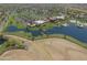 Aerial view showing clubhouse, pool, and lake at 42521 W Sea Eagle Dr, Maricopa, AZ 85138