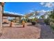 Gravel backyard with pergola and desert plants at 42521 W Sea Eagle Dr, Maricopa, AZ 85138