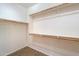 Large walk-in closet with shelving and hanging rods at 42521 W Sea Eagle Dr, Maricopa, AZ 85138