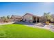 Backyard with artificial turf and covered patio at 43808 W Wade Dr, Maricopa, AZ 85138