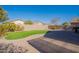 Landscaped backyard with artificial turf and patio at 43808 W Wade Dr, Maricopa, AZ 85138