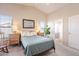 Bright bedroom with a queen bed, two nightstands, and access to bathroom at 43808 W Wade Dr, Maricopa, AZ 85138