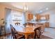 Bright dining room with a wooden table and chairs, and large windows at 43808 W Wade Dr, Maricopa, AZ 85138