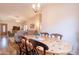 View of the dining room from the kitchen, showing a wooden table and chairs at 43808 W Wade Dr, Maricopa, AZ 85138