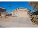 Single-story home with desert landscaping and a two-car garage at 43808 W Wade Dr, Maricopa, AZ 85138