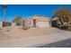 Single-story home with desert landscaping and a two-car garage at 43808 W Wade Dr, Maricopa, AZ 85138