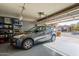 Garage with an SUV and storage shelving at 43808 W Wade Dr, Maricopa, AZ 85138