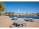 Picnic tables overlooking a community lake at 43808 W Wade Dr, Maricopa, AZ 85138