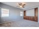 Bright bedroom with carpet flooring, built-in shelving, and ceiling fan at 4444 E Peach Tree Dr, Chandler, AZ 85249