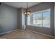 Charming dining room featuring a window with pool view and a unique light fixture at 4444 E Peach Tree Dr, Chandler, AZ 85249