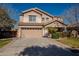 Two-story house with tan exterior, landscaped lawn, and attached garage at 4444 E Peach Tree Dr, Chandler, AZ 85249