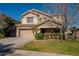 Two-story house with tan exterior, landscaped lawn, and attached garage at 4444 E Peach Tree Dr, Chandler, AZ 85249