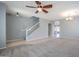 Living room with staircase, ceiling fan, and view into kitchen area at 4444 E Peach Tree Dr, Chandler, AZ 85249