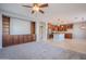 Living room with built-in shelving, ceiling fan and carpet flooring at 4444 E Peach Tree Dr, Chandler, AZ 85249