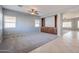 Spacious living room with tile and carpeted floors, ceiling fan, and built-in shelving at 4444 E Peach Tree Dr, Chandler, AZ 85249