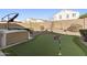 Landscaped backyard with hot tub and putting green at 4916 E Rhodium Dr, San Tan Valley, AZ 85143