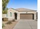 Charming single-story home with a two-car garage and well-maintained front yard at 4916 E Rhodium Dr, San Tan Valley, AZ 85143