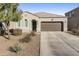 Single-story home with a two-car garage and desert landscaping at 4916 E Rhodium Dr, San Tan Valley, AZ 85143