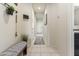 Light-filled hallway with a bench and golf club storage at 4916 E Rhodium Dr, San Tan Valley, AZ 85143