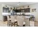 Spacious kitchen with an island, stainless steel appliances, and dark cabinets at 4916 E Rhodium Dr, San Tan Valley, AZ 85143