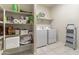 Laundry room with washer, dryer, and storage shelves at 4916 E Rhodium Dr, San Tan Valley, AZ 85143