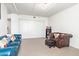 Living room featuring tile flooring, comfortable seating, and ample closet space for storage and organization at 535 W Thomas Rd # 208, Phoenix, AZ 85013