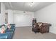 Living room with teal sofa, brown leather chair, and built-in shelving at 535 W Thomas Rd # 208, Phoenix, AZ 85013