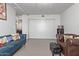 Living room with teal sofa, brown leather chair, and built-in shelving at 535 W Thomas Rd # 208, Phoenix, AZ 85013