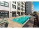 Refreshing pool area with lounge chairs and a building view at 535 W Thomas Rd # 208, Phoenix, AZ 85013