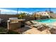 Poolside barbecue area with a grill and lounge chairs, offering a perfect setting for outdoor entertainment and relaxation at 535 W Thomas Rd # 208, Phoenix, AZ 85013