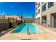 Community pool area with blue water, surrounded by a patio and fencing, perfect for relaxation and recreation at 535 W Thomas Rd # 208, Phoenix, AZ 85013