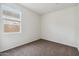 Bright bedroom with carpet and large window at 5515 E Rock Bush Ln, San Tan Valley, AZ 85140