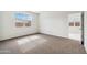 Well-lit bedroom with carpet flooring and large window at 5515 E Rock Bush Ln, San Tan Valley, AZ 85140