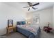 Bedroom with queen bed, ceiling fan, and two nightstands at 5704 E Butte St, Mesa, AZ 85205