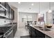 Modern kitchen featuring dark cabinetry and granite countertops at 5704 E Butte St, Mesa, AZ 85205