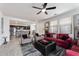 Open living space with red couch and view into kitchen at 5704 E Butte St, Mesa, AZ 85205