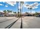 Attractive community entrance with palm trees and circular drive at 5757 W Eugie Ave # 2078, Glendale, AZ 85304