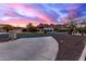 Curved driveway leading to a modern home, with mountain backdrop and landscaping at 5818 N 45Th St, Phoenix, AZ 85018