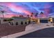 Modern home exterior with gray stucco, palm trees, and attached two-car garage at 5818 N 45Th St, Phoenix, AZ 85018