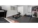 Home gym with a weight bench, treadmill, and free weights at 5818 N 45Th St, Phoenix, AZ 85018