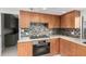 Sleek kitchen with wood cabinets and a mosaic backsplash at 5818 N 45Th St, Phoenix, AZ 85018