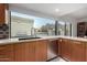 Modern kitchen features wood cabinets, stainless steel appliances, and a mountain view at 5818 N 45Th St, Phoenix, AZ 85018