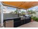 Modern outdoor kitchen with grill, sink, and ample counter space at 5818 N 45Th St, Phoenix, AZ 85018