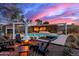 Luxury pool and patio area with fire pit, lounge chairs, and sunset view at 5818 N 45Th St, Phoenix, AZ 85018