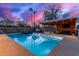 Modern rectangular pool with spa, covered patio, and colorful sunset at 5818 N 45Th St, Phoenix, AZ 85018