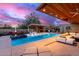 Expansive pool with multiple seating areas, covered patio, and fire feature at 5818 N 45Th St, Phoenix, AZ 85018